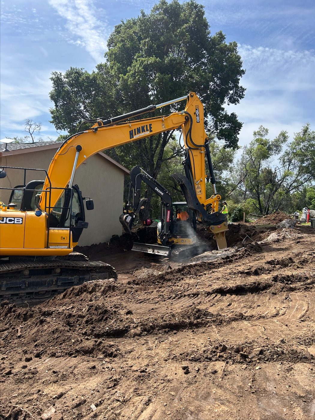 Excavator performing earthwork and grading